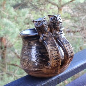 Big medieval clay mug with owl heads