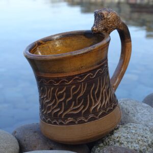 Big medieval clay mug with dragon head